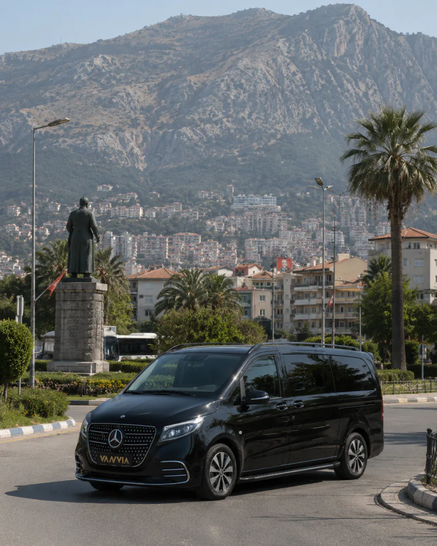 Vanvia Mercedes-Benz Vito VIP parked at a city square corner with a monument statue, apartment blocks and a mountain in the background